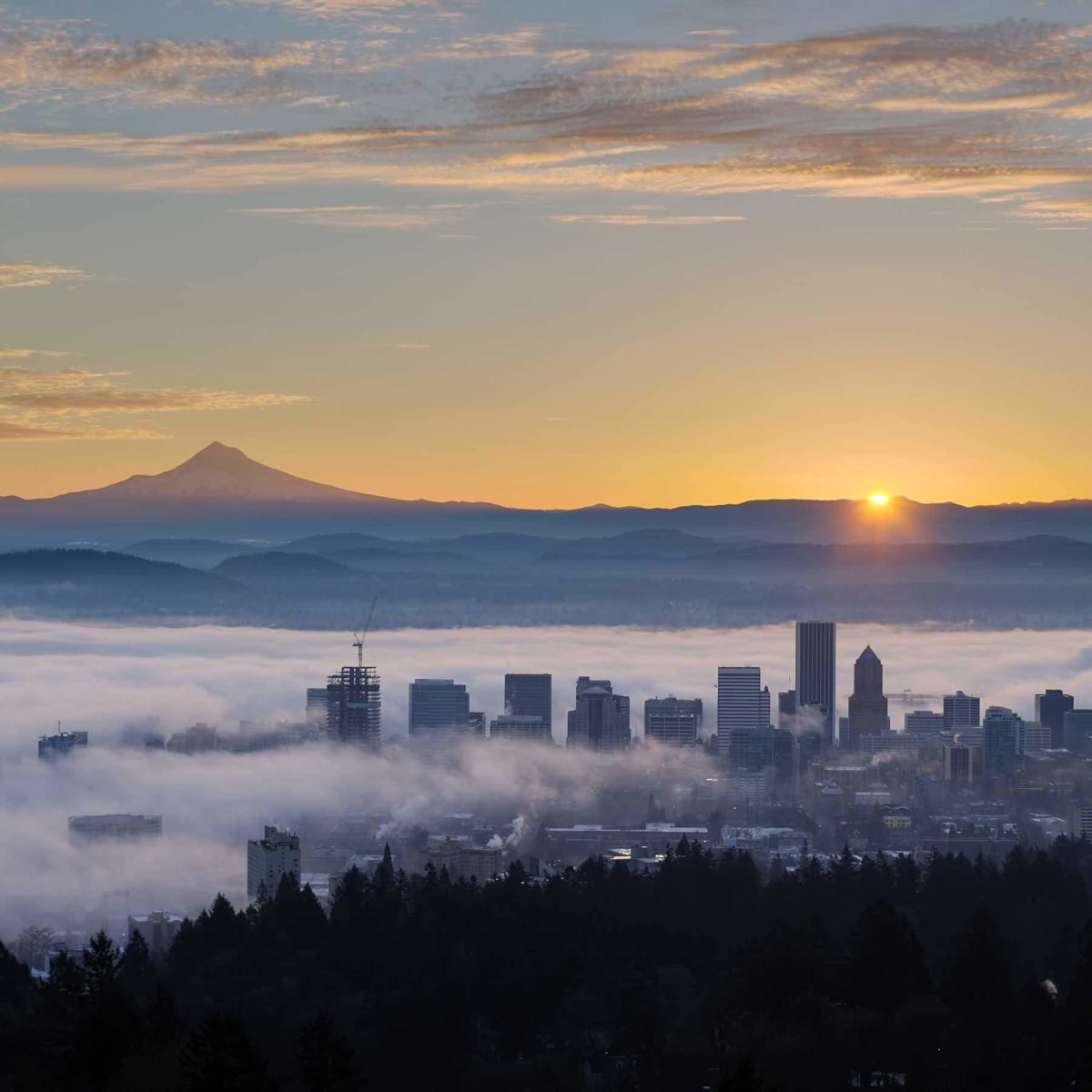 Sun setting over Portland with views of Mt. Hood